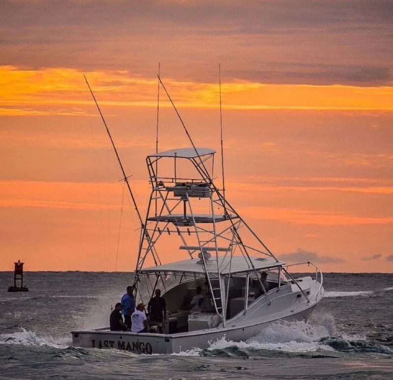 A boat with two people on it in the ocean.