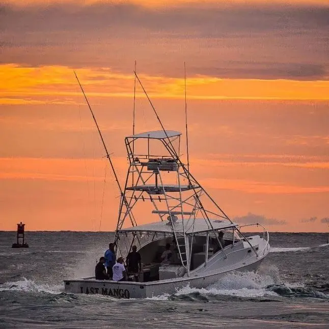 A boat with two people on it in the ocean.