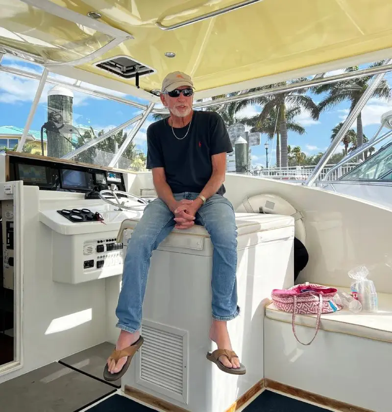 A man sitting on the back of a boat.